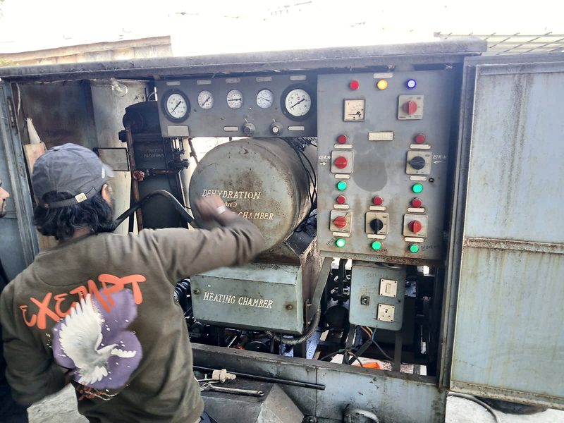 Technician operating an electrical test and control panel